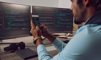 Two different phones showing an old and a new app interface, symbolizing migration.